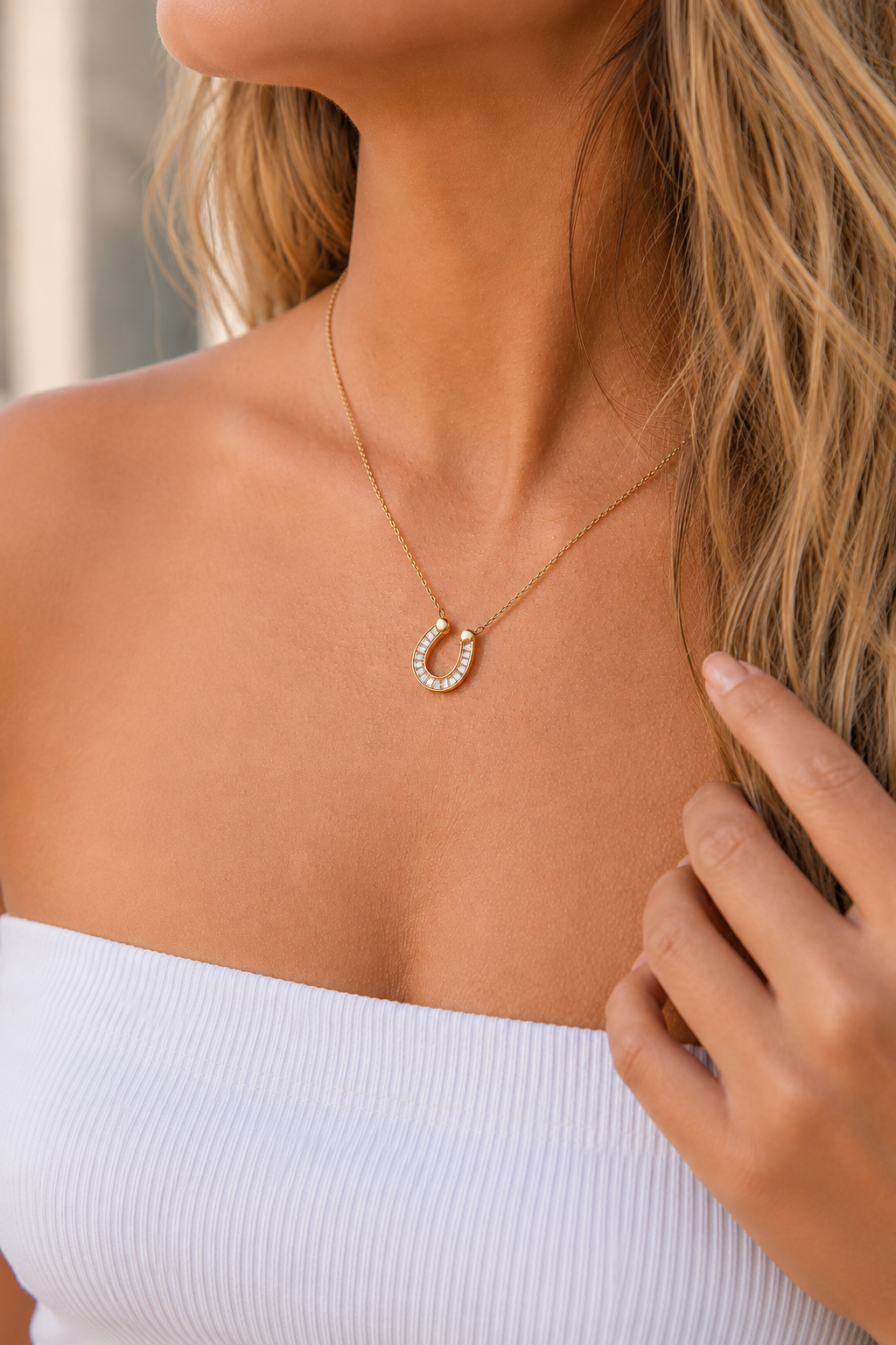 Gold horseshoe necklace with sparkling crystal pendant, delicate chain, and adjustable extender, waterproof hypoallergenic jewelry